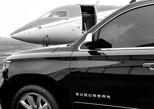 Luxury SUV parked beside private jet on tarmac