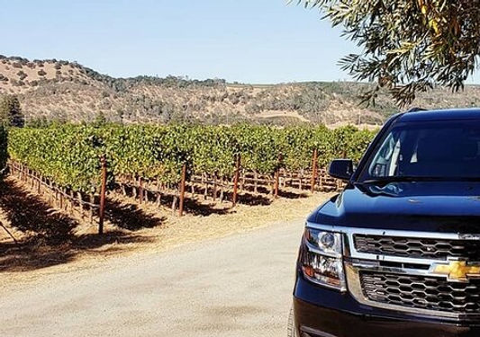 Luxury SUV parked at Hill Country vineyard